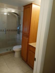 a bathroom with a toilet and a glass shower at Beautiful Miami Home in Miami +15 photos