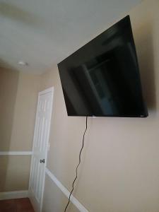 a flat screen tv hanging on a wall at Beautiful Miami Home in Miami