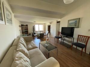 a living room with a couch and a tv at La Casa Escondida in Sabiote