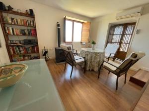 a living room with a table and chairs at La Casa Escondida in Sabiote