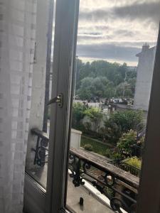 an open door to a balcony with a view at Chambre de 9m2 in Bagnolet
