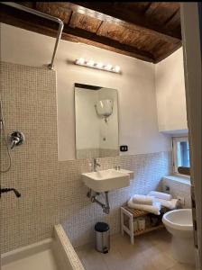 a bathroom with a sink and a toilet and a mirror at Navona Suite Rome - quite and view in Rome