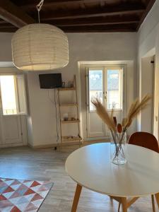 a dining room with a table and a vase of flowers at Navona Suite Rome - quite and view in Rome