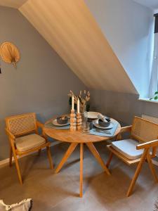 a dining room with a table and two chairs at AS Pavan Saarlouis Ferienwohnung in Saarlouis +7 photos