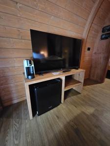 a living room with a large flat screen tv at Vicolungo Glamour Lodge & SPA - Free SPA Hot Tub e Sauna in Vicolungo +34 photos