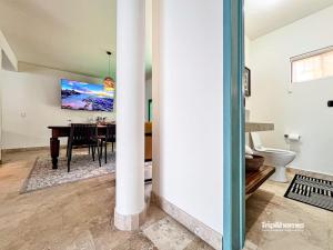 Una televisión o centro de entretenimiento en Casa Serendity Beautiful 4Br 4Ba home one block from Malecon