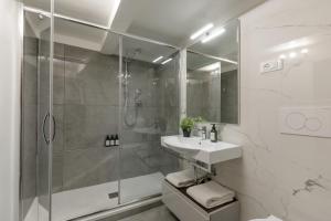 a white bathroom with a shower and a sink at The Right Place 4U Monserrato Apartment in Rome +10 photos