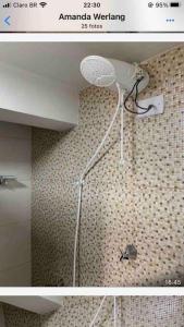 a bathroom with a shower with a spider on the wall at casa jardim Eliza in Foz do Iguaçu