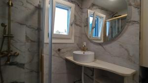 a bathroom with a sink and a mirror at Emerald Blue in Skiathos +39 photos