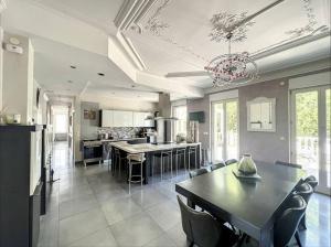 a large kitchen with a table and a dining room at Villa Alba avec piscine et Spa in Metz
