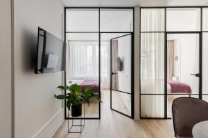 a room with glass doors and a potted plant at Old City apart in Lviv