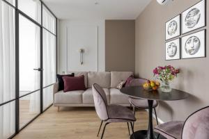 a living room with a table and a couch at Old City apart in Lviv