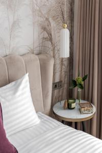 a bedroom with a bed and a side table at Old City apart in Lviv