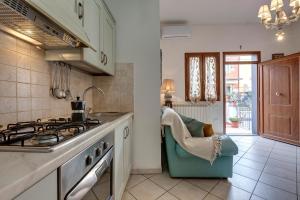 a kitchen with a sink and a stove top oven at A casa di Greta in Prato