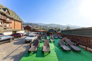 a row of chaise lounge chairs sitting on a street at La Кrechunu in Bukovel