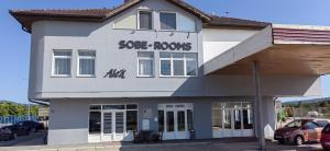 a white building with the words sore arrows on it at Rooms ALEA in Sanski most