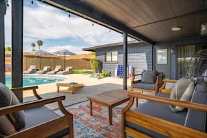 a screened in porch with chairs and a pool at Basketball Court Heated Pool Mini Golf & More in Glendale