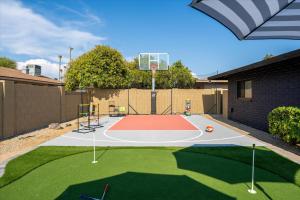 a basketball hoop in a backyard with a basketball court at Basketball Court Heated Pool Mini Golf & More in Glendale