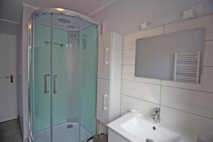 a bathroom with a glass shower and a sink at La treille in Saint-Hilaire-La-Treille +9 photos