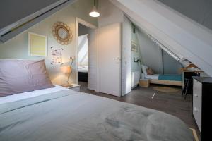 a bedroom with a large bed and an attic at Toekomst 26 - Ouddorp NOT INTENDED FOR COMPANY OR WORK-RELATED STAYS in Oude Nieuwland