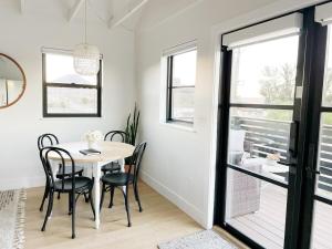 a dining room with a table and chairs and a window at Black Barn Ranch Hill Views Downtown Close in San Luis Obispo