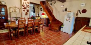 a kitchen and dining room with a table and a refrigerator at Charming Country House In The Heart Of Burgundy in Cormatin