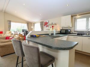 a kitchen and living room with a large counter top at 21 Norman Drive Lodge in Great Yarmouth +13 photos