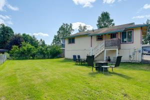 a yard with chairs and a table in front of a house at 6 Mi to Dtwn Bright and Airy Anchorage Getaway! in Anchorage