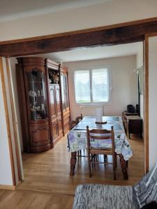 a living room with a table and a chair at Appartement familial avec jardin et vue sur lac à Clairac, 80 m² in Clairac