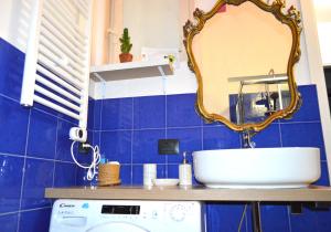 a bathroom with a sink and a mirror at Flat Liberty Turin center Porta Susa, reserved parking in Turin +34 photos
