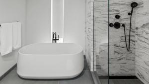 a white toilet in a bathroom with a shower at 4F One Spruce Peak Stowe Mountain Resort Ski in Ski Out 4 bed Sleeps 10 in Stowe +27 photos