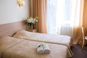 Postel nebo postele na pokoji v ubytování Hotel SPA Arkadia