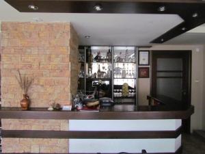 a bar in a room with a brick wall at Guest House Raffe in Dobrinishte
