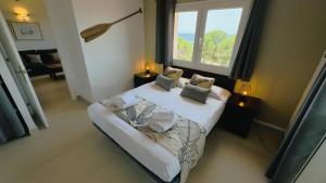 a small bedroom with a bed and a window at Villa BONA VISTA in Son Bou +68 photos