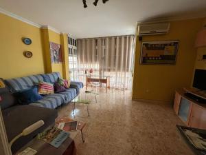 a living room with a couch and a table at Rooms Tourist Apartment in Huelva