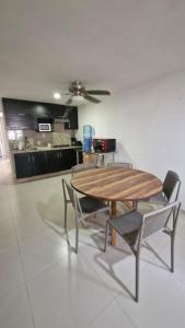a table and chairs in a room with a kitchen at Tranquilidad cerca del mar in Bucerías +11 photos