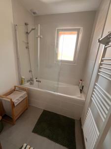 a bathroom with a shower and a bath tub at Maison à Lacanau Océan in Lacanau-Océan +8 photos