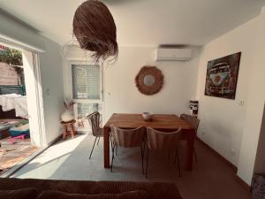 a dining room with a wooden table and chairs at Maison à Lacanau Océan in Lacanau-Océan