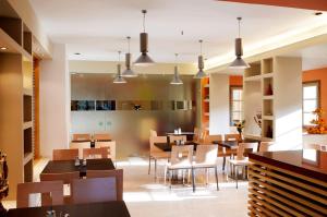 a restaurant with wooden tables and chairs and lights at Astoria Hotel in Troulos