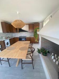 a kitchen with a wooden table and chairs in it at Lilium Maison in Canosa Sannita