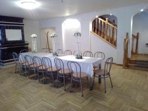 a room with a white table and chairs with flowers at Travel home in Riga