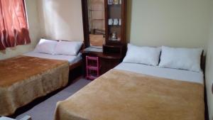 Кровать или кровати в номере Haranya Homestay