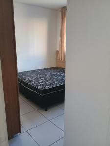 a small room with a bed in the corner at Condomínio ville park collete in Betim