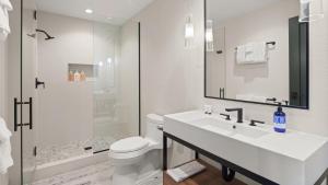 a bathroom with a sink and a toilet and a shower at New Spruce Peak Tree House Unit Steps To The Lifts With Big Mountain Views Sleeps 9 By Stowe Mountain Rentals in Stowe +11 photos