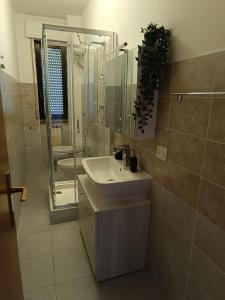a bathroom with a sink and a glass shower at Appartamento vista mare Vasto Marina in Marina di Montenero