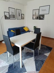 a table and chairs in a room with a couch at Appartamento vista mare Vasto Marina in Marina di Montenero