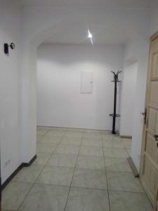 an empty room with a cross on the wall and a door at Travel home in Riga