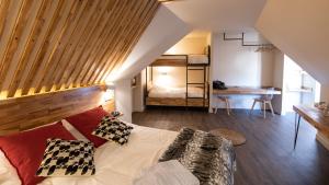 a bedroom with a bed and a bunk room at L'ORIGINE in Saint-Aubin