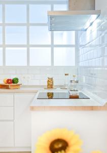 a white kitchen with a sink and a window at Loft El Charco De San Ginés in Arrecife