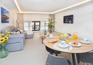 a living room with a table with food on it at Loft El Charco De San Ginés in Arrecife +14 photos